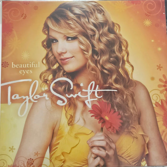 Taylor Swift holding a red flower on a vinyl record cover with a yellow and orange background. Taylor swift beautiul eyes vinyl record